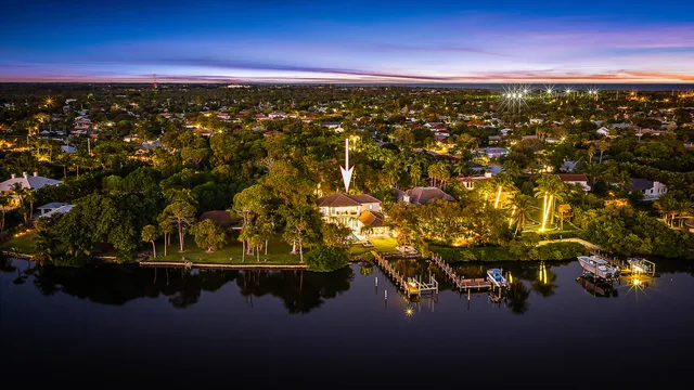 a view of a house with a swimming pool and a yard