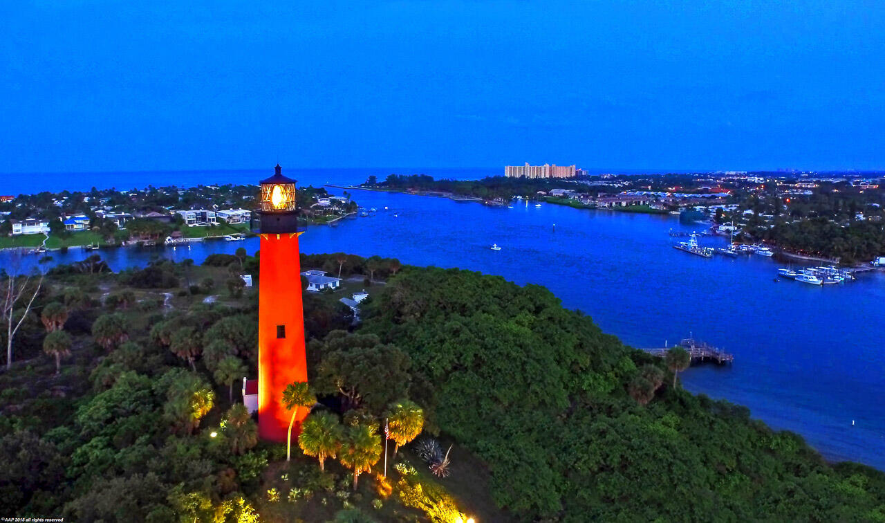 19651 North Riverside Drive Jupiter, FL 33469 - Photo 33 of 37 a view of a house with a swimming pool and a yard
