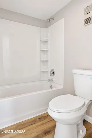 a bathroom with a toilet a sink and bathtub