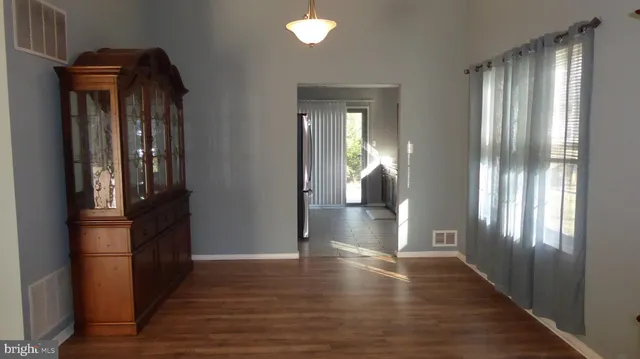a view of hallway with wooden floor