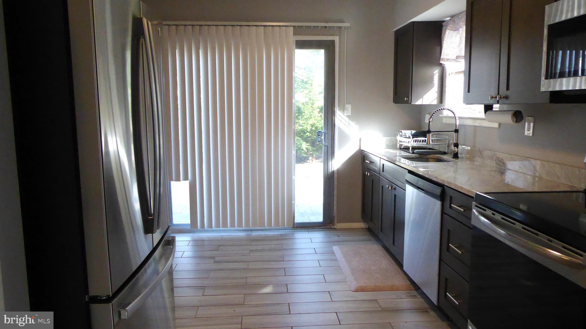 4 Hamilton Court Berlin, NJ 08009 - Photo 14 of 46 a kitchen with stainless steel appliances granite countertop a sink stove and refrigerator