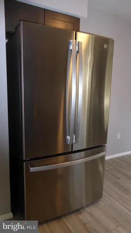 a kitchen with a window and wooden floor