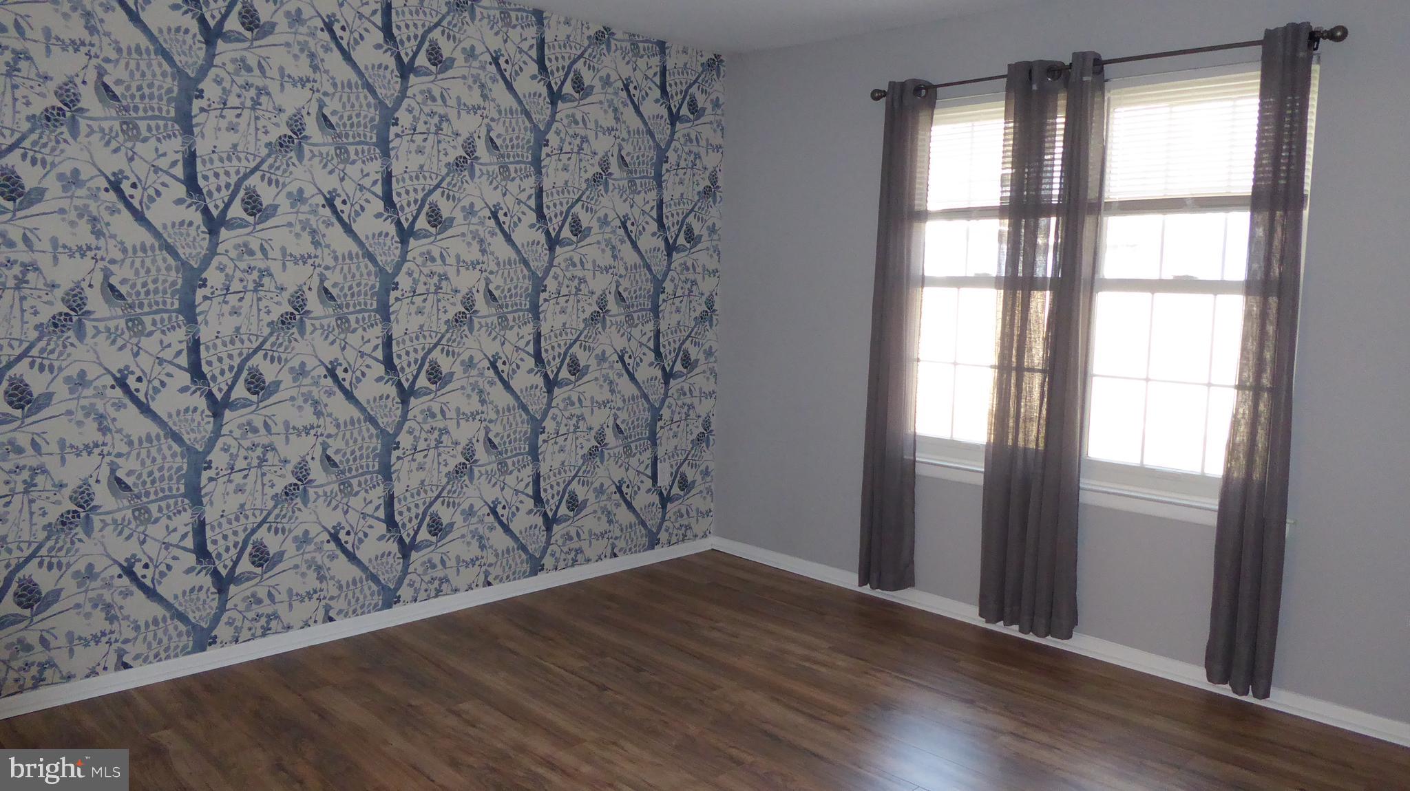 4 Hamilton Court Berlin, NJ 08009 - Photo 19 of 46 an empty room with wooden floor and windows