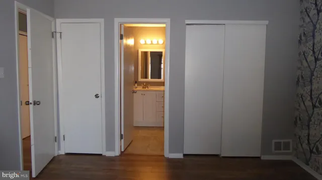 a view of a small space with wooden floor and a window