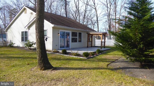 a view of a house with a yard covered in snow