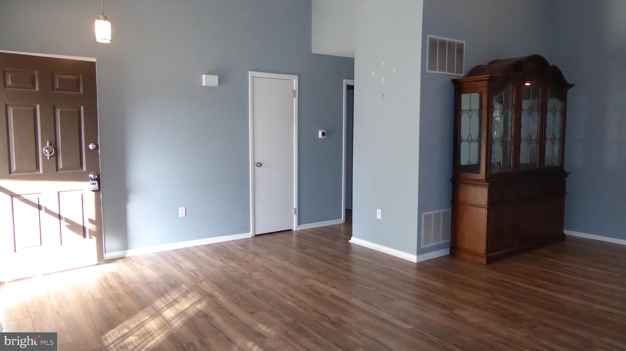 4 Hamilton Court Berlin, NJ 08009 - Photo 7 of 46 a view of an empty room with wooden floor and a window