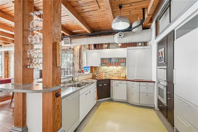 a kitchen with granite countertop white cabinets and white appliances