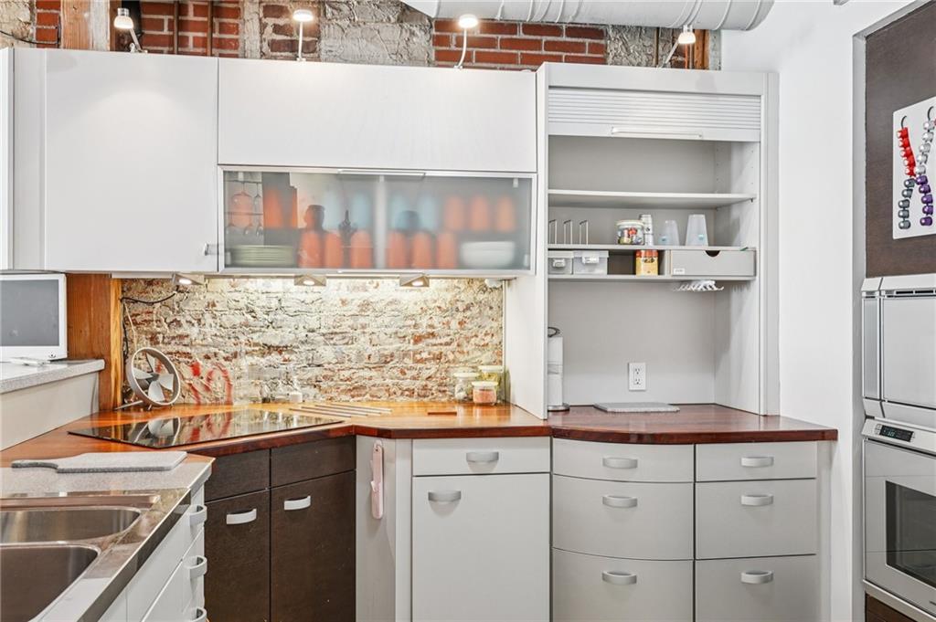 205 Walker Street Southwest, Unit G8 Atlanta, GA 30313 - Photo 17 of 41 a kitchen with granite countertop white cabinets and white appliances