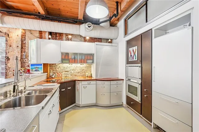 a kitchen with granite countertop a sink and cabinets