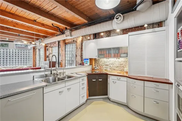 a view of a kitchen with a sink and cabinets