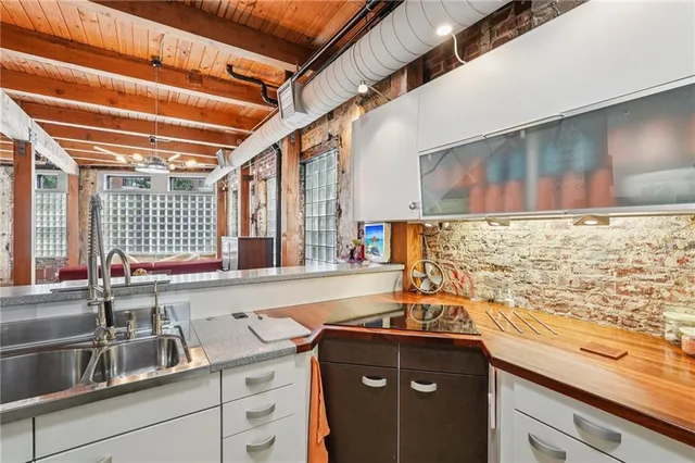 a view of a kitchen with a sink and a refrigerator