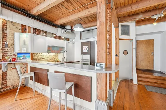 a view of front door with chair and wooden floor