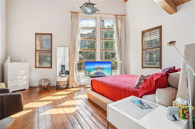 a bedroom with bed and wooden floor