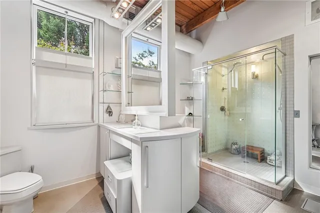 a bathroom with a toilet a sink and a window