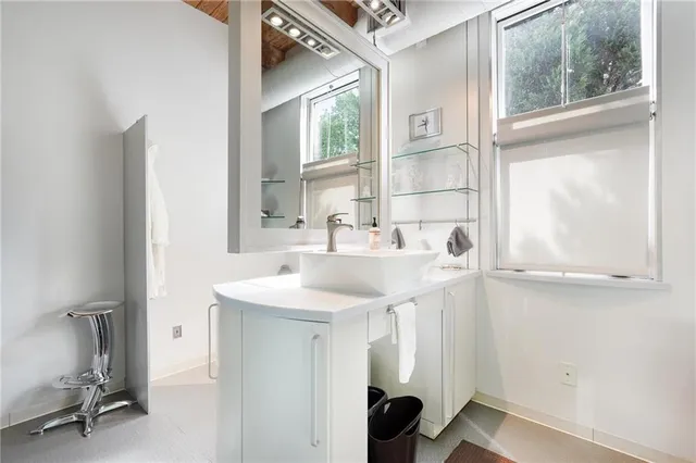 a bedroom with furniture and a large window