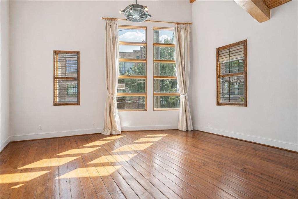 205 Walker Street Southwest, Unit G8 Atlanta, GA 30313 - Photo 5 of 41 a view of an empty room with wooden floor and a window