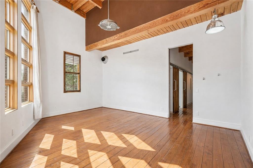 205 Walker Street Southwest, Unit G8 Atlanta, GA 30313 - Photo 6 of 41 a view of an empty room with wooden floor and a window