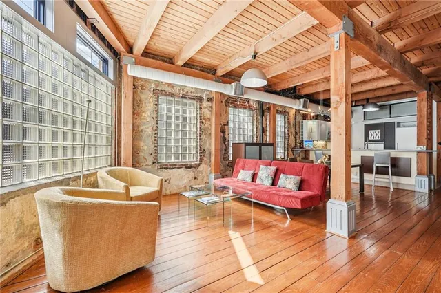 a living room with furniture and floor to ceiling window