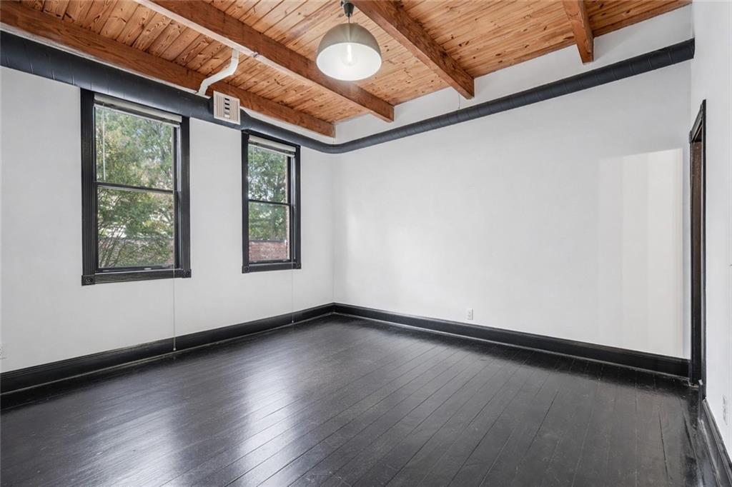 205 Walker Street Southwest, Unit G8 Atlanta, GA 30313 - Photo 7 of 41 a view of an empty room with wooden floor and fan