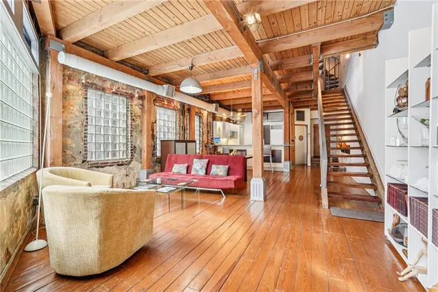 a living room with furniture and a book shelf
