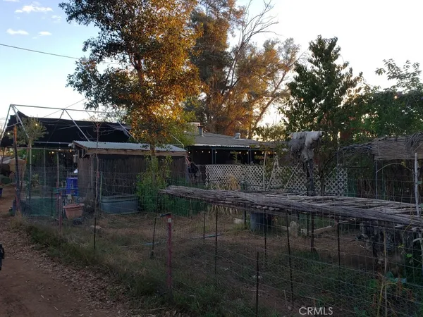 a view of house with outdoor space and garden