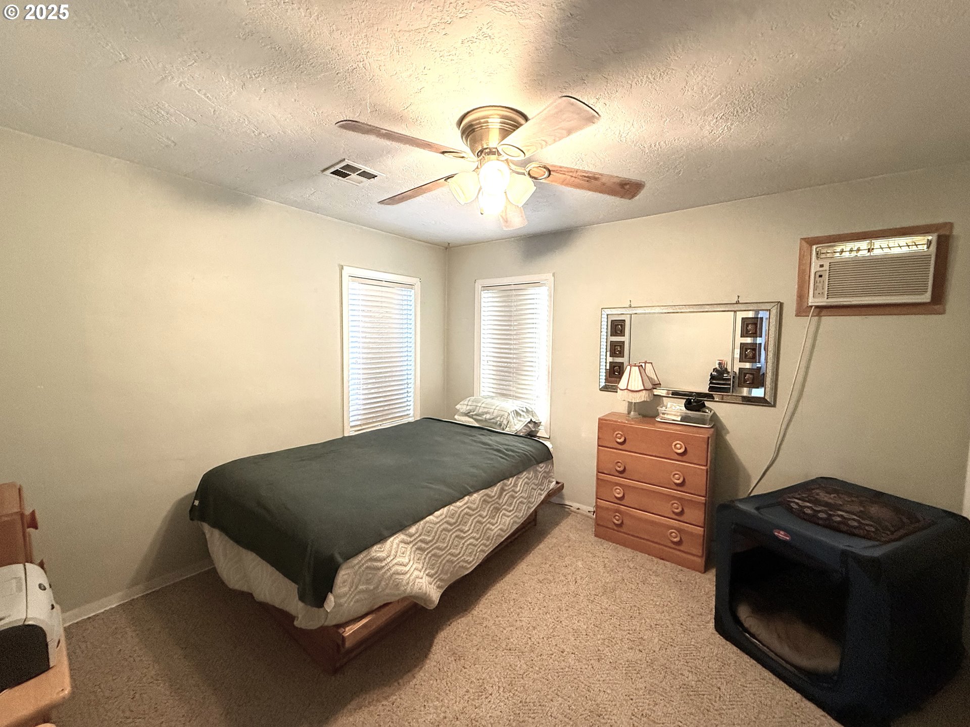 2076 Roberts Road Medford, OR 97504 - Photo 15 of 29 a bedroom with a bed and a chandelier