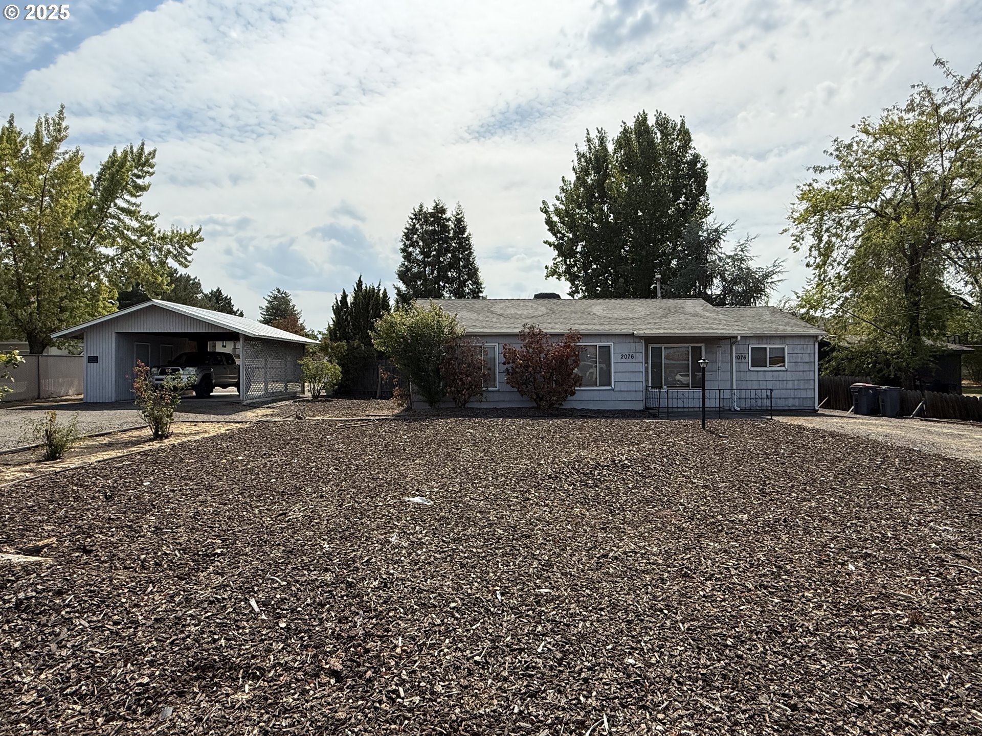 2076 Roberts Road Medford, OR 97504 - Photo 6 of 29 a front view of a house with a garden