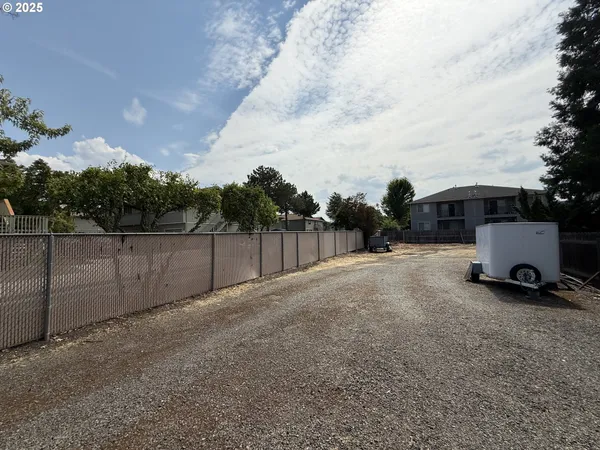 a view of a house with a yard and tree