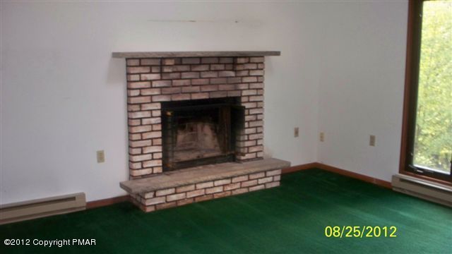 770 Regent Street Bushkill, PA 18324 - Photo 3 of 8 a living room with a fireplace