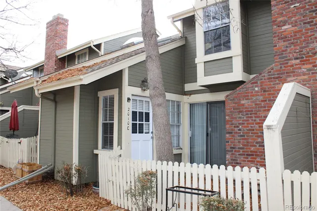 a front view of a house with a fence