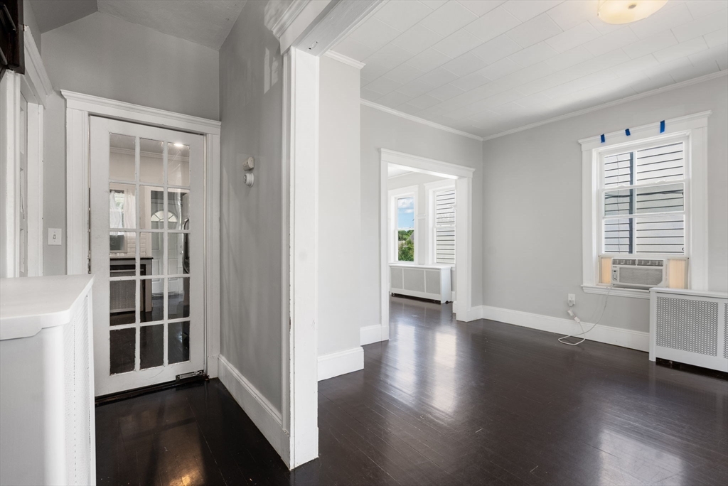 460 Beech Street Boston, MA 02131 - Photo 12 of 25 an empty room with wooden floor and windows