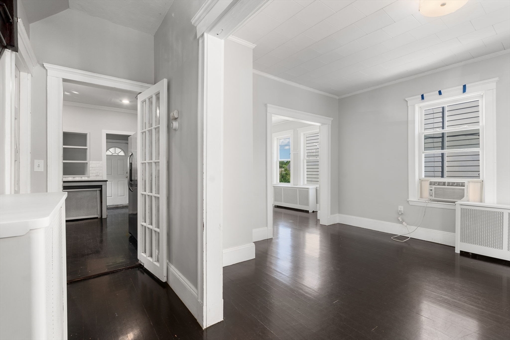 460 Beech Street Boston, MA 02131 - Photo 13 of 25 an empty room with wooden floor and windows