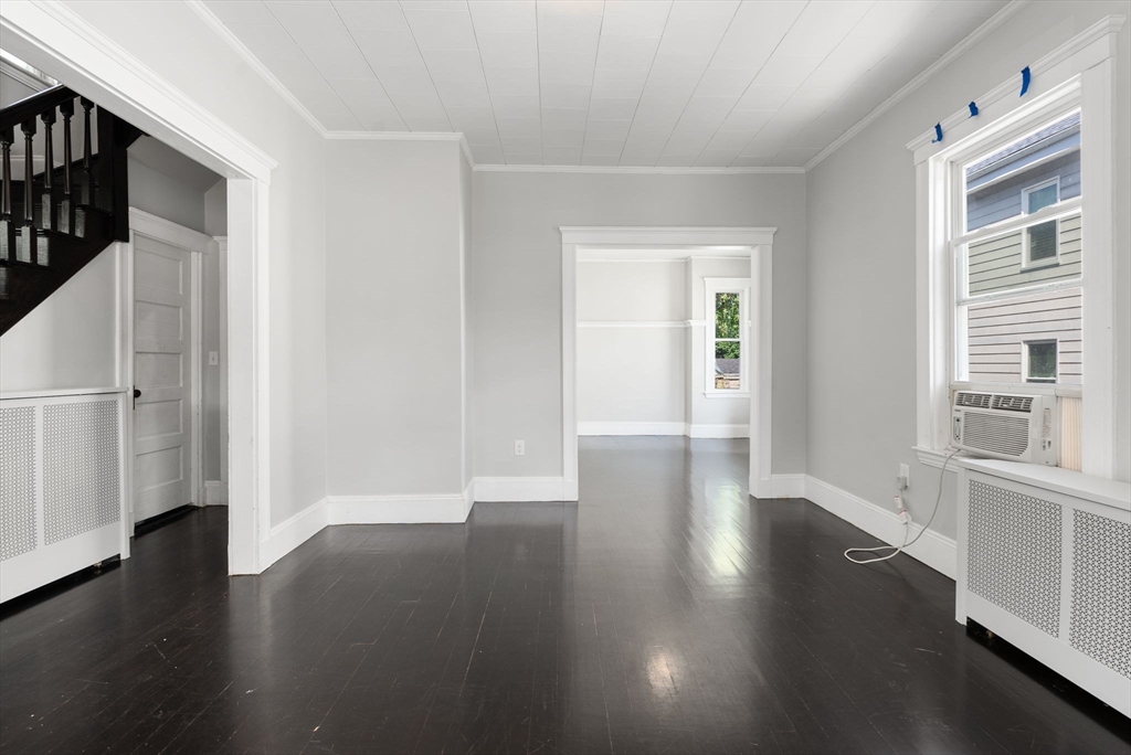 460 Beech Street Boston, MA 02131 - Photo 14 of 25 an empty room with wooden floor and windows