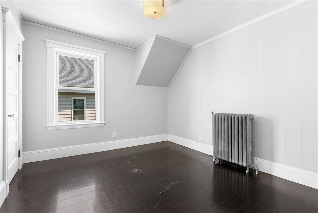 460 Beech Street Boston, MA 02131 - Photo 15 of 25 an empty room with a window and wooden floor