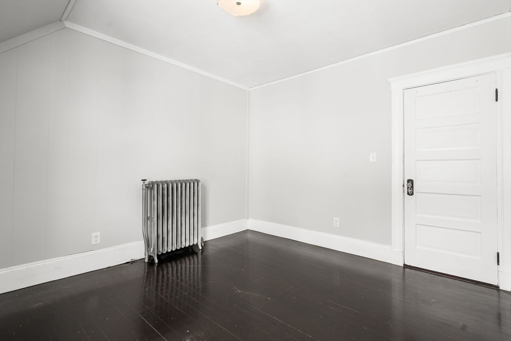 460 Beech Street Boston, MA 02131 - Photo 16 of 25 an empty room with wooden floor