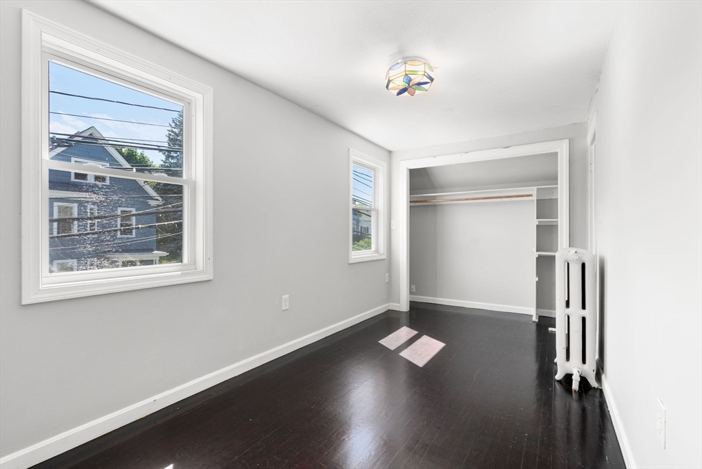 460 Beech Street Boston, MA 02131 - Photo 18 of 25 a view of a livingroom with wooden floor and a window
