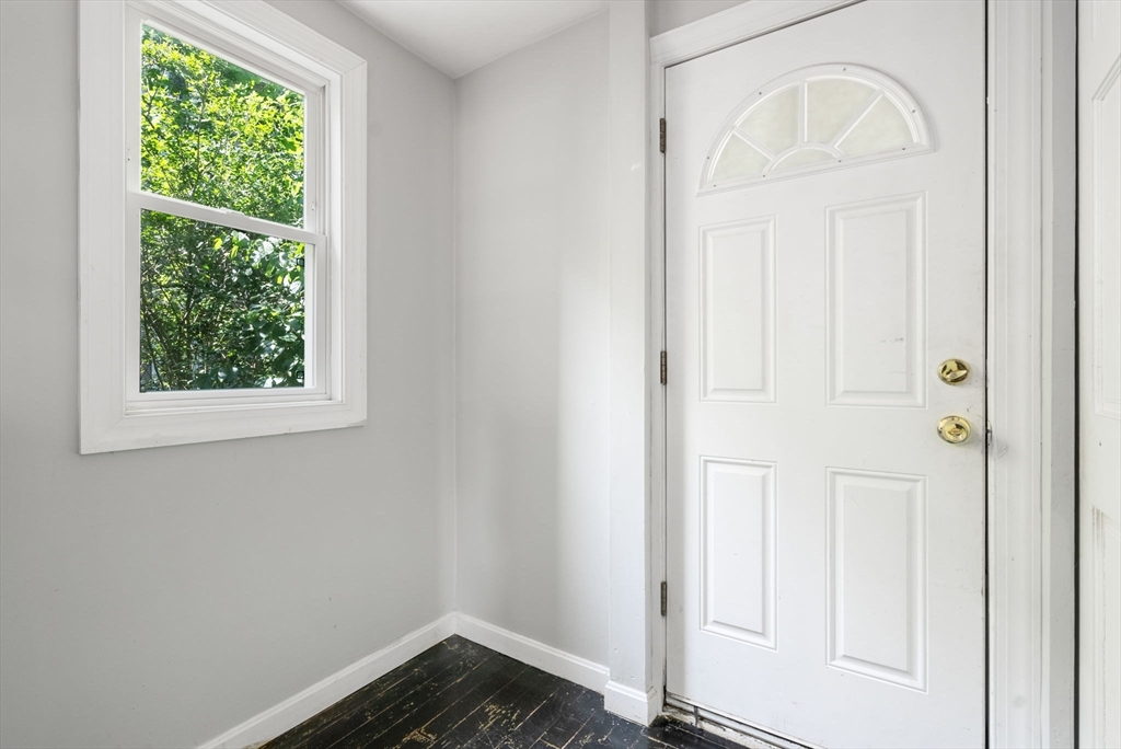 460 Beech Street Boston, MA 02131 - Photo 23 of 25 an empty room with wooden floor closet and windows