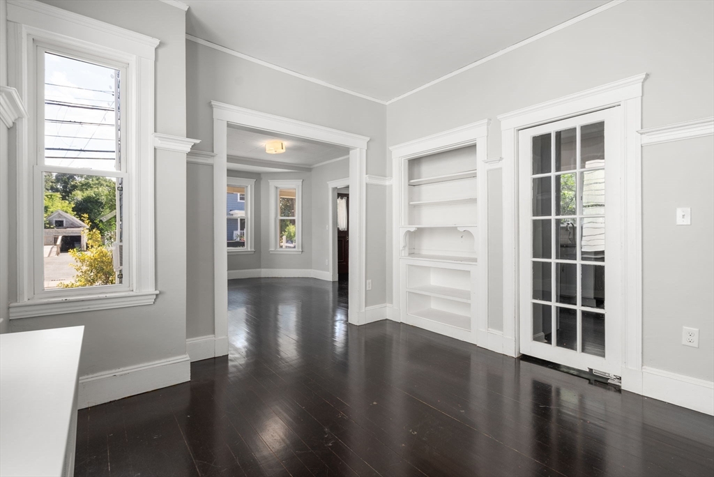 460 Beech Street Boston, MA 02131 - Photo 7 of 25 a view of empty room with wooden floor and windows