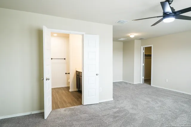 a view of a hallway with wooden floor and a cabinet
