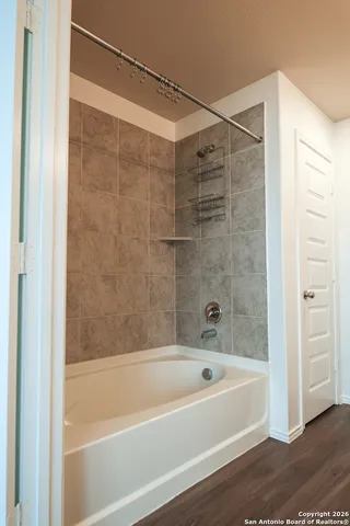 a bathroom with a bathtub and a shower