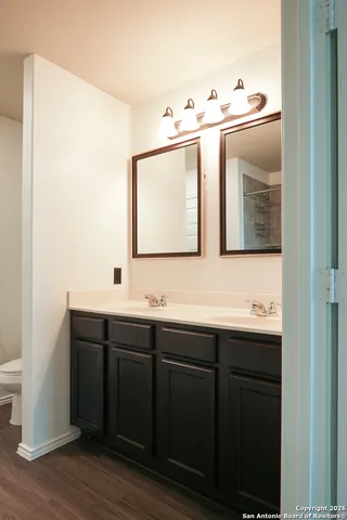 a bathroom with a double vanity sink and mirror