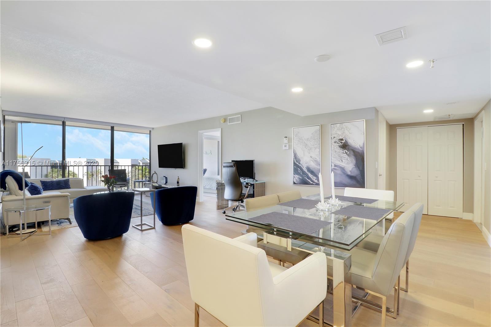 1300 Florida A1A, Unit 325 Jupiter, FL 33477 - Photo 11 of 44 a living room with furniture a large window and a table