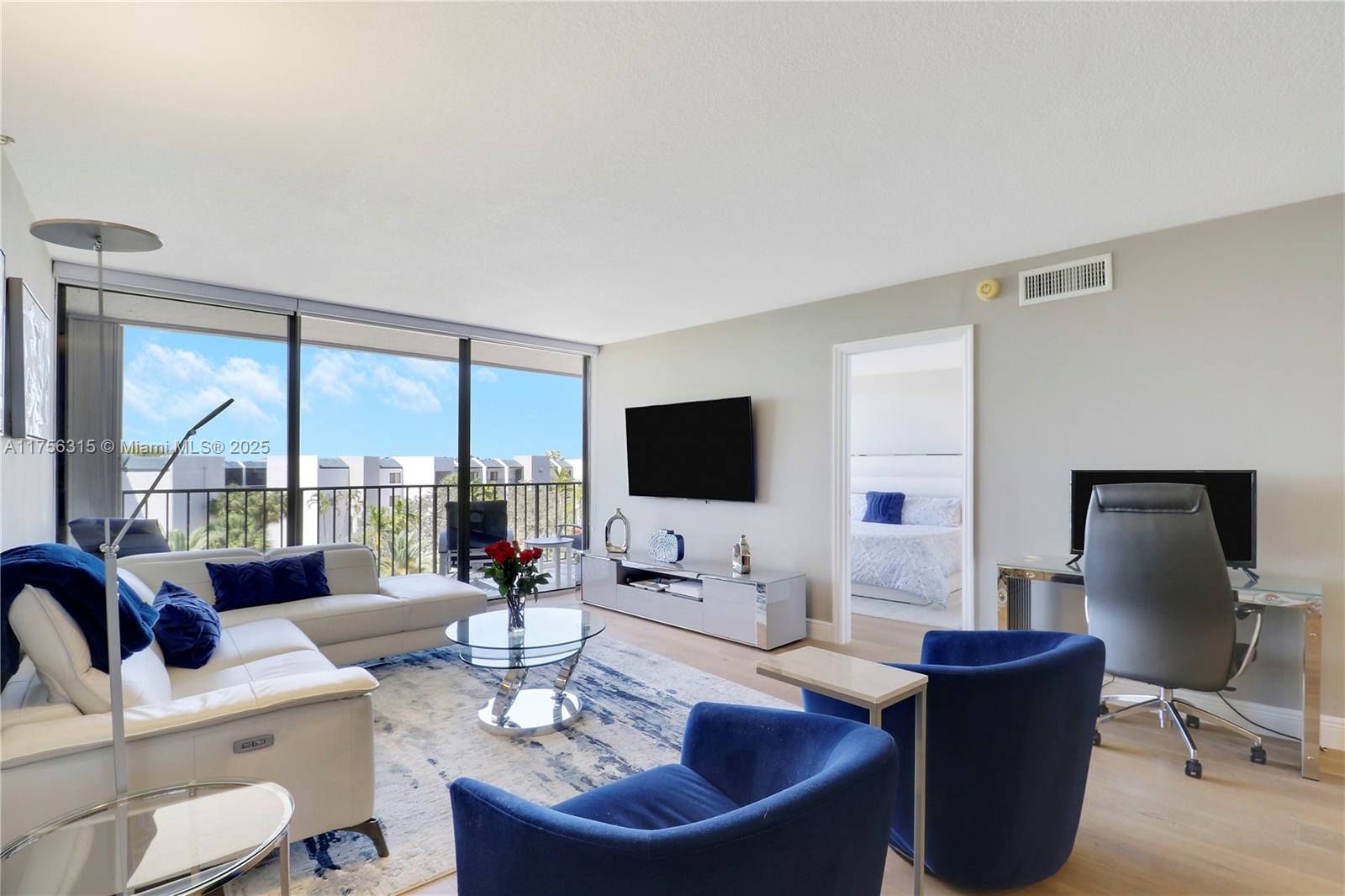 1300 Florida A1A, Unit 325 Jupiter, FL 33477 - Photo 13 of 44 a living room with furniture a large window and a flat screen tv