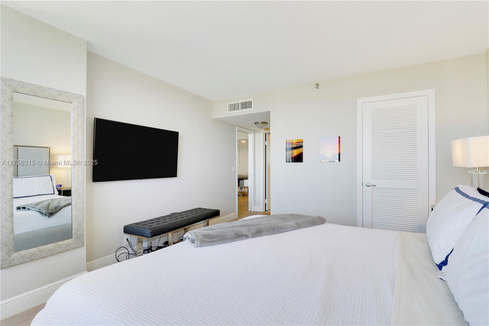 1300 Florida A1A, Unit 325 Jupiter, FL 33477 - Photo 18 of 44 a bedroom with a bed and a flat screen tv