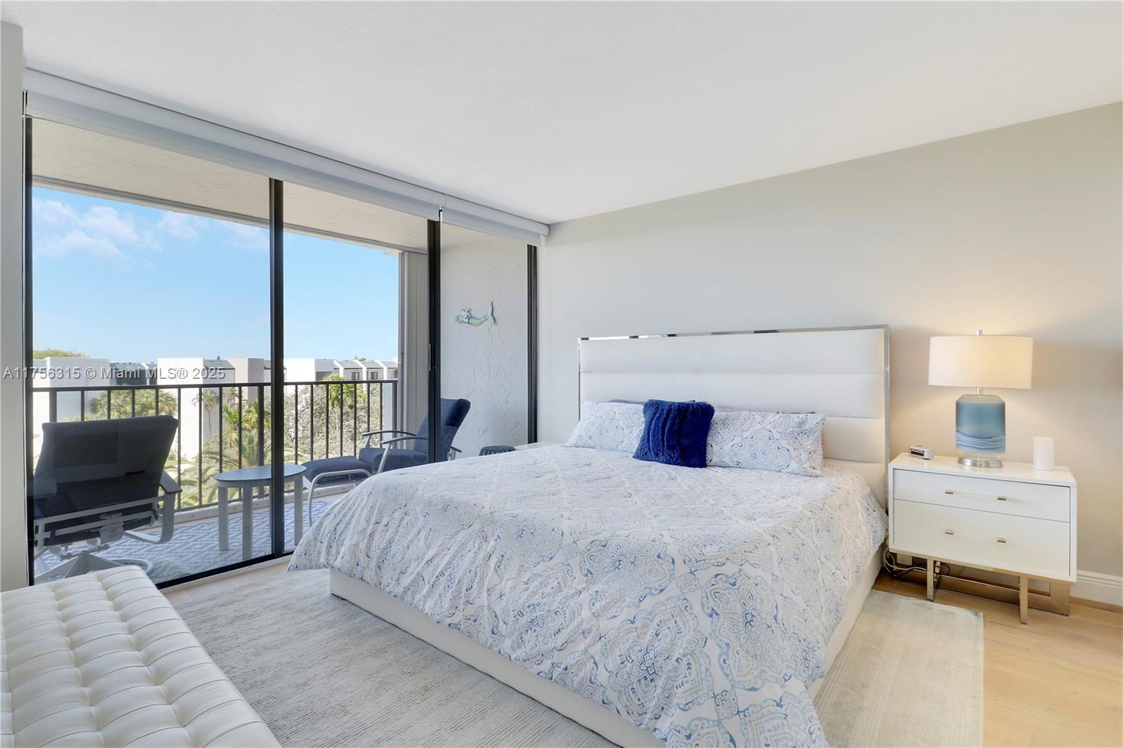 1300 Florida A1A, Unit 325 Jupiter, FL 33477 - Photo 21 of 44 a bedroom with a large bed and a flat tv screen next to a large window