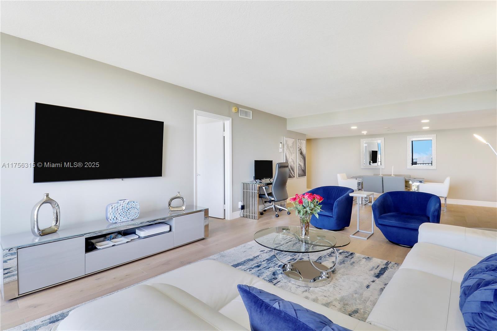 1300 Florida A1A, Unit 325 Jupiter, FL 33477 - Photo 24 of 44 a living room with furniture and a flat screen tv