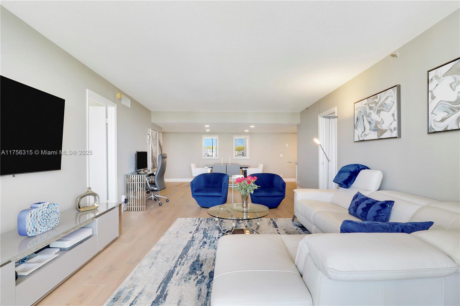 1300 Florida A1A, Unit 325 Jupiter, FL 33477 - Photo 25 of 44 a living room with furniture and a flat screen tv