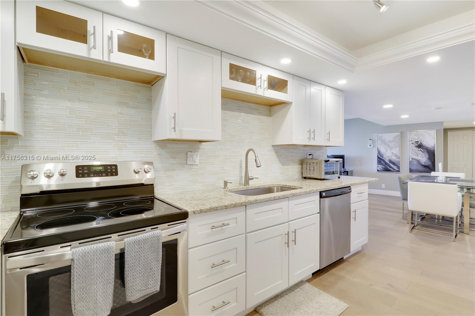1300 Florida A1A, Unit 325 Jupiter, FL 33477 - Photo 6 of 44 a kitchen with a sink stove and cabinets