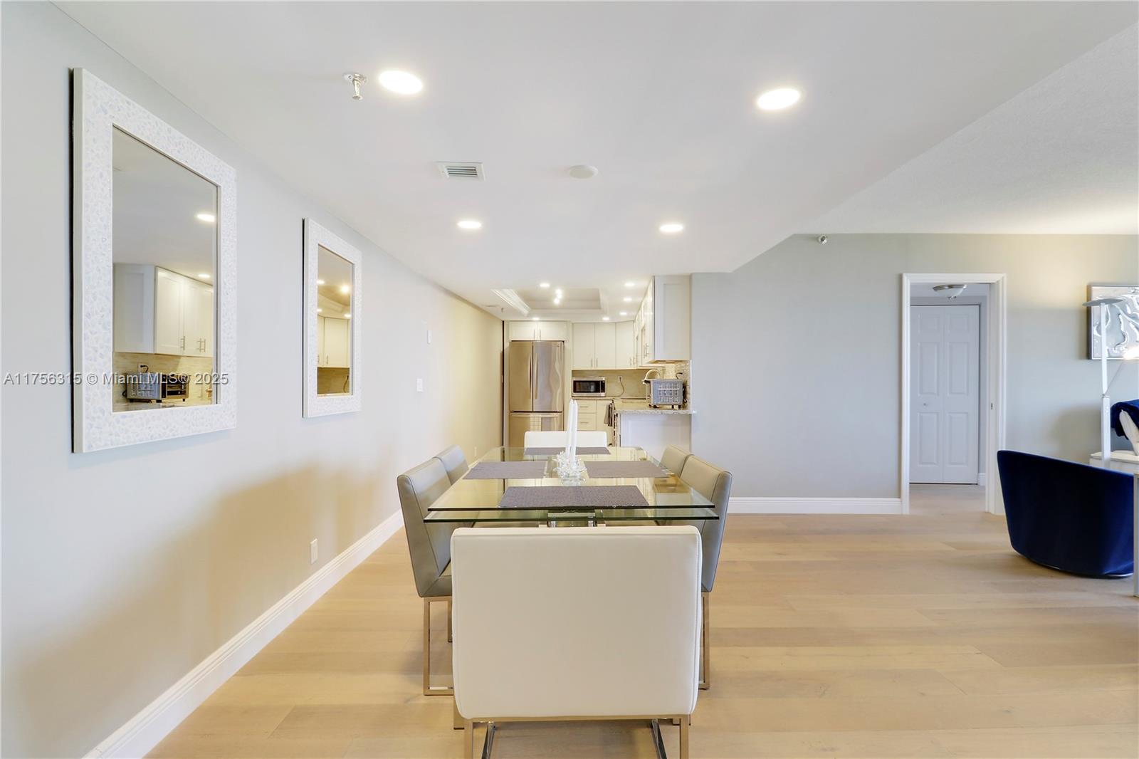 1300 Florida A1A, Unit 325 Jupiter, FL 33477 - Photo 8 of 44 a dining hall with stainless steel appliances kitchen island granite countertop a sink and a refrigerator