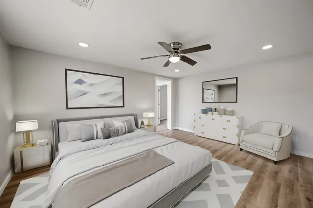 a bedroom with a large bed couch and window